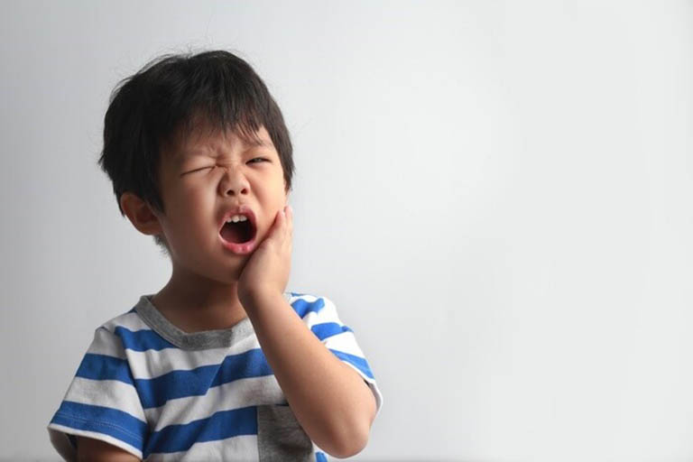 Trẻ bị đau răng thường có biểu hiện sưng một bên má, mệt mỏi, biếng ăn